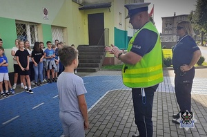 Na zdjęciu policjanci wspólnie z dziećmi podczas akcji Bezpieczna droga do szkoły.