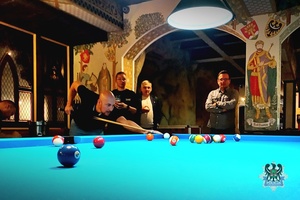 Na zdjęciu zawodnik podczas gry przy stole bilardowym.