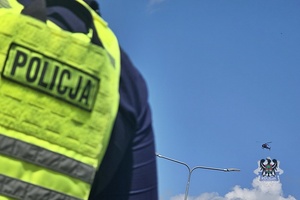 Na zdjęciu policjant podczas zabezpieczenia zawodów na trasie.