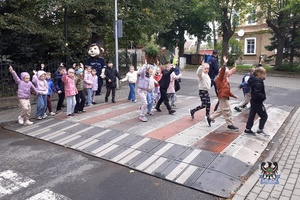 Na zdjęciu policjanci i dzieci podczas działań bezpieczna droga do szkoły.