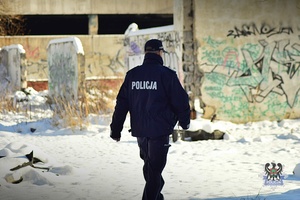 Na zdjęciu policjant w trakcie sprawdzania miejsc, w których mogą przebywać osoby bezdomne.
