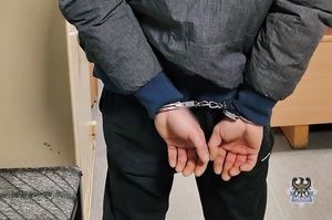 Na zdjeciu kajdanki na ręce zatrzymanego.