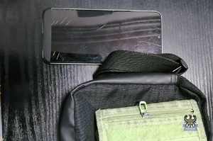 Na zdjęciu odzyskany telefon oraz saszetka i portfel.
