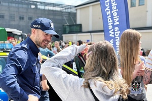 Na zdjęciu policjant wraz z uczestnikami akcji "Razem. Bezpiecznie. Skutecznie."