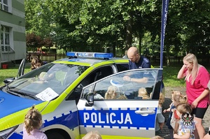 Na zdjęciu policjant w trakcie spotkania z młodymi mieszkańcami miasta.
