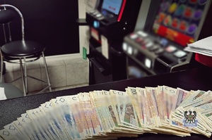 Na zdjęciu gotówka oraz zabezpieczone automaty.