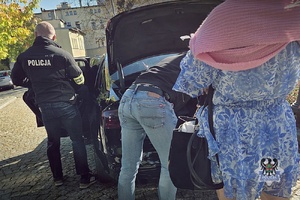 Na zdjęciu policjanci przeszukują samochód.